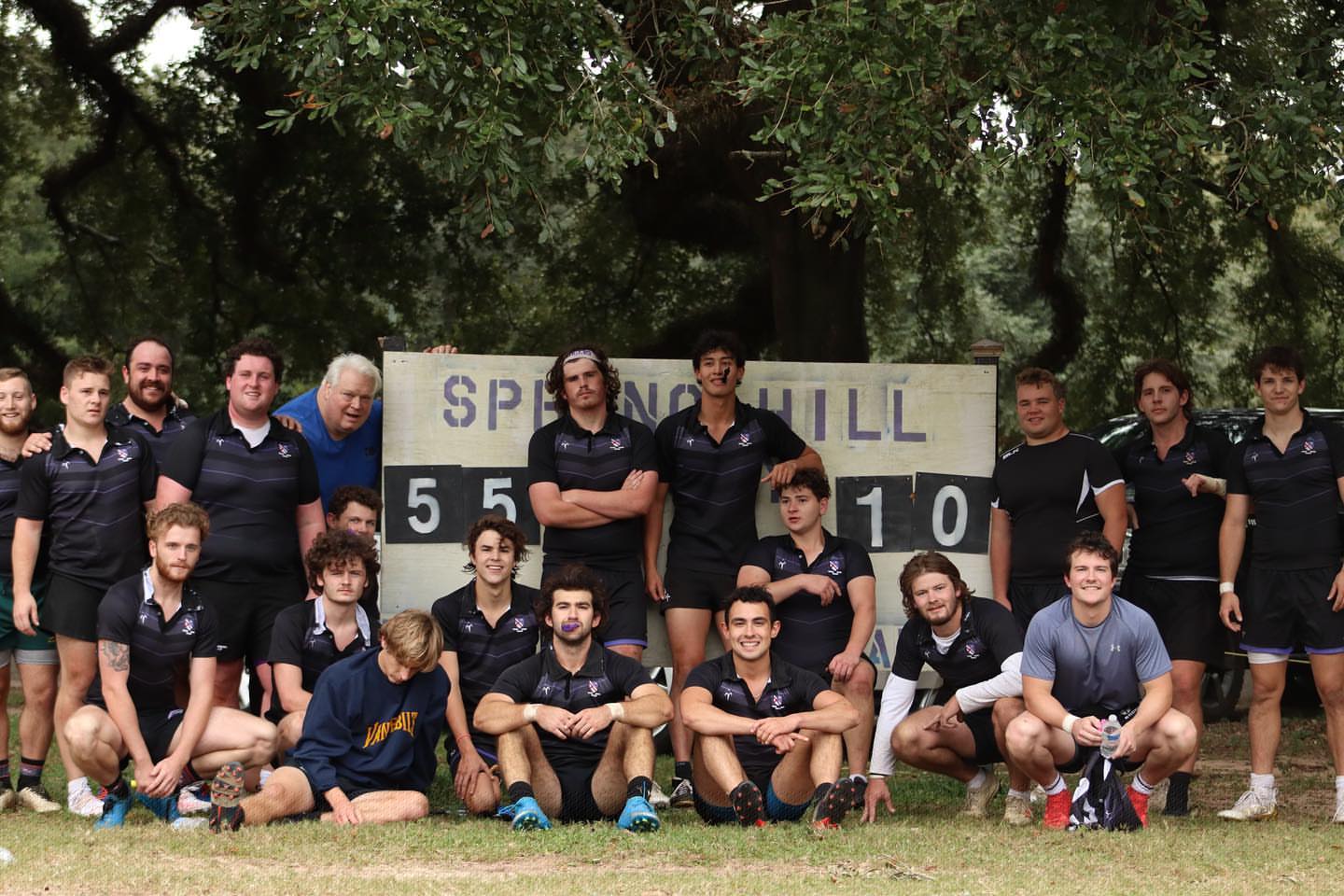 The Spring Hill College rugby team posing at the scoreboard on Dorn Field