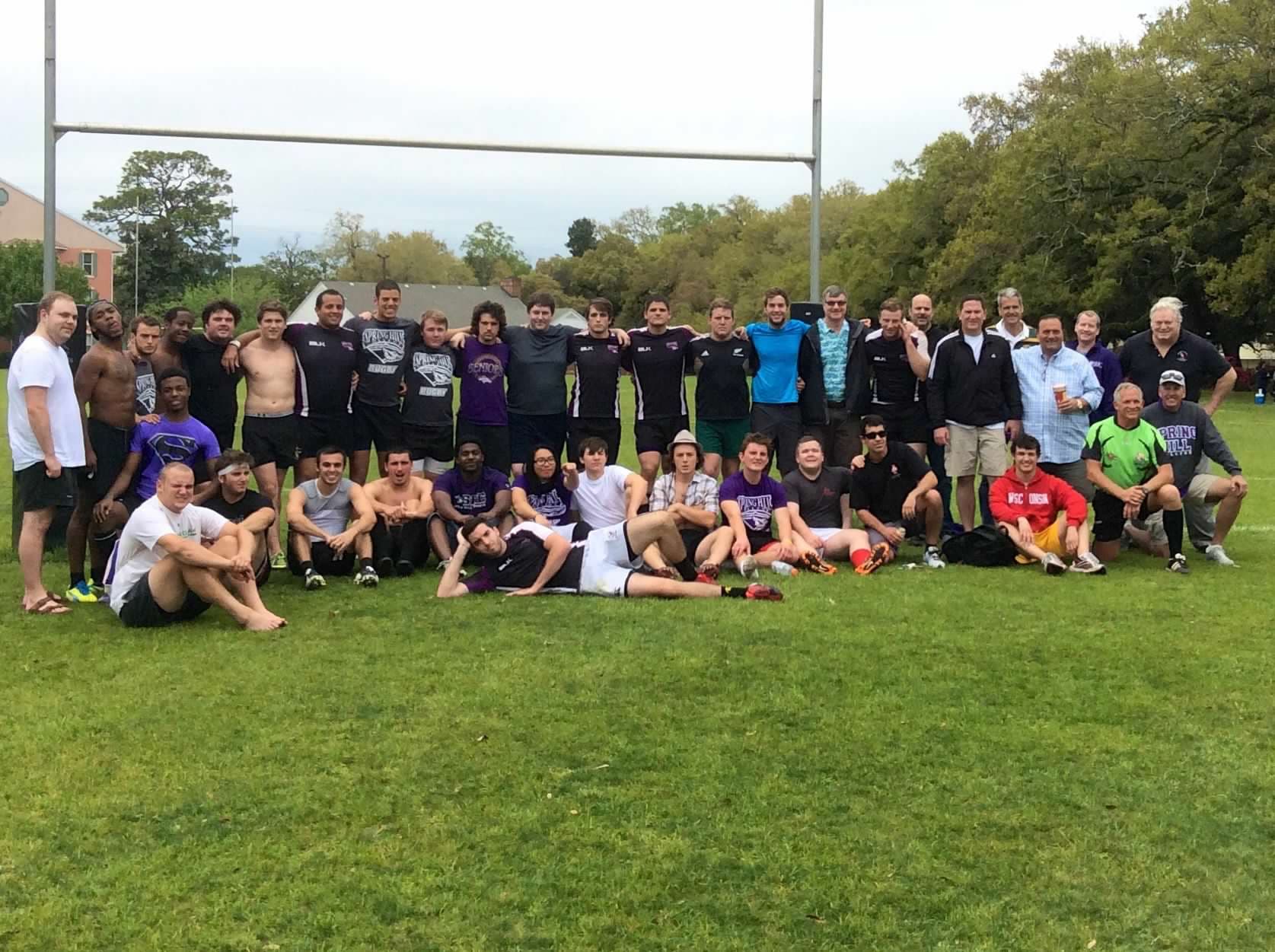 The Spring Hill Badgers squad and alumni gathered under the posts on Dorn Field